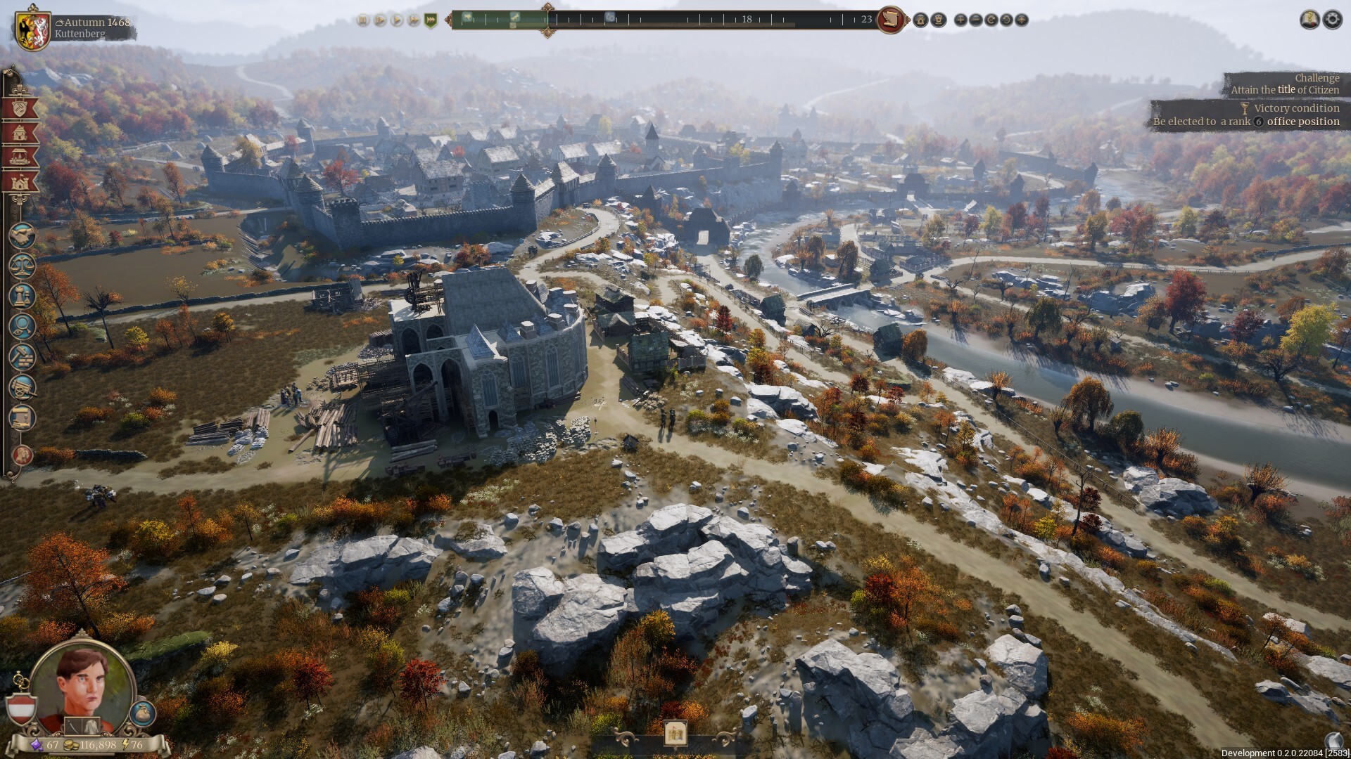 The Guild 1 Remake: Europa 1410 — Aerial view of a medieval settlement with stone walls, a large ruined cathedral, scattered buildings, and autumnal trees surrounding rocky terrain.
